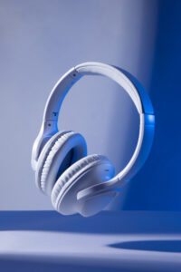 White noise cancelling over ear headphones on blue background for programming and coding