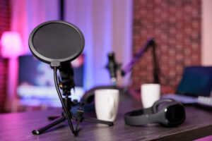 USB condenser microphone with pop filter on desk setup for podcasting, programming, and video calls